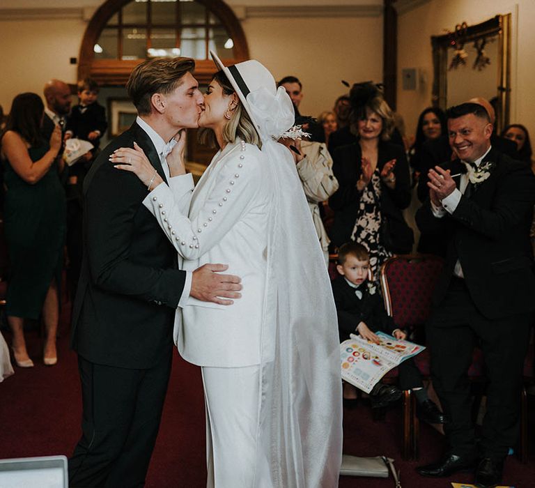 Bride and groom share their first kiss as a married couple 