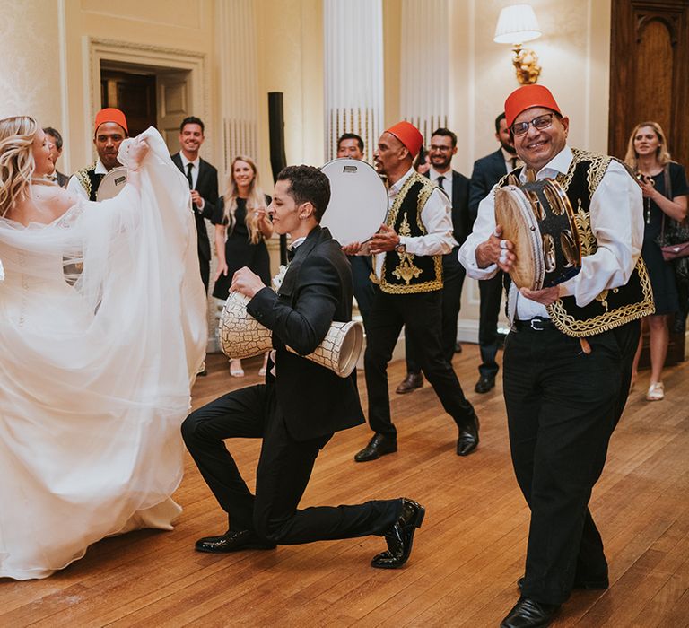 Bride and groom dance with their wedding entertainment Zaffa band 