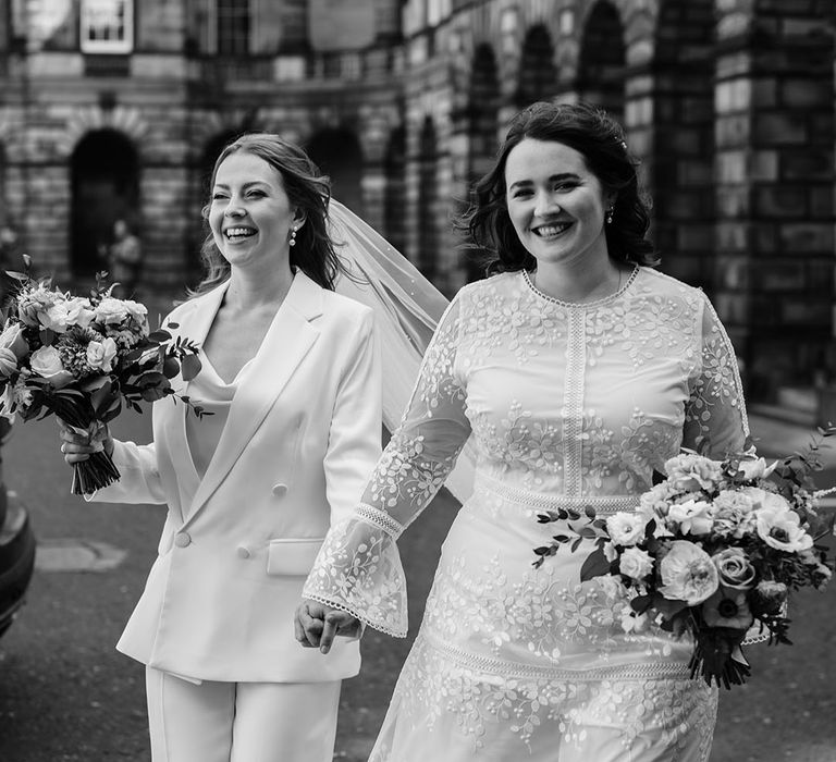 Brides leave ceremony in black and white image