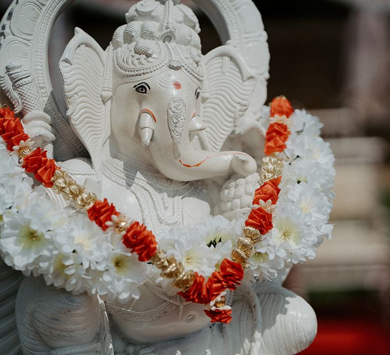 Florals placed upon neck of Hindu God Ganesha 