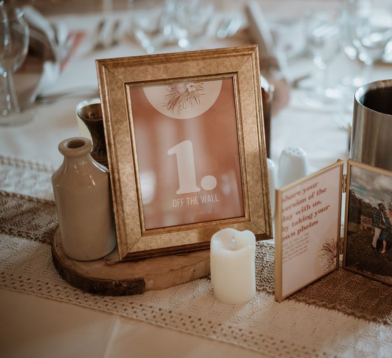 Wedding table name signs based on the couple's favourite albums with a photo of the bride and groom 