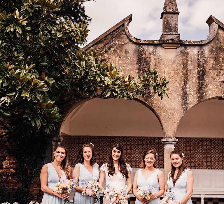 Bridesmaids in light blue bridesmaid dresses with the bride for bridal party wedding photo 