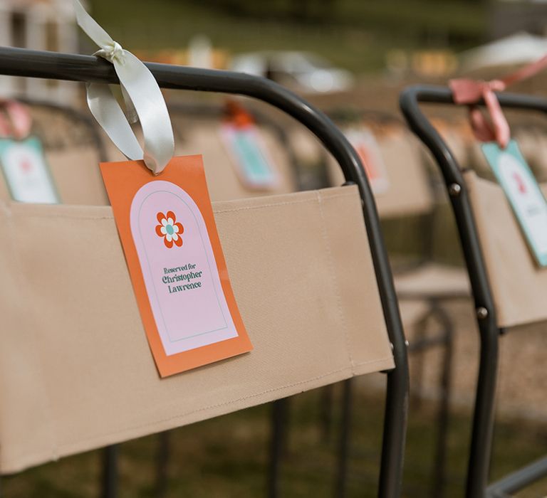 Bright and colourful orange and pink flower wedding chair tag 