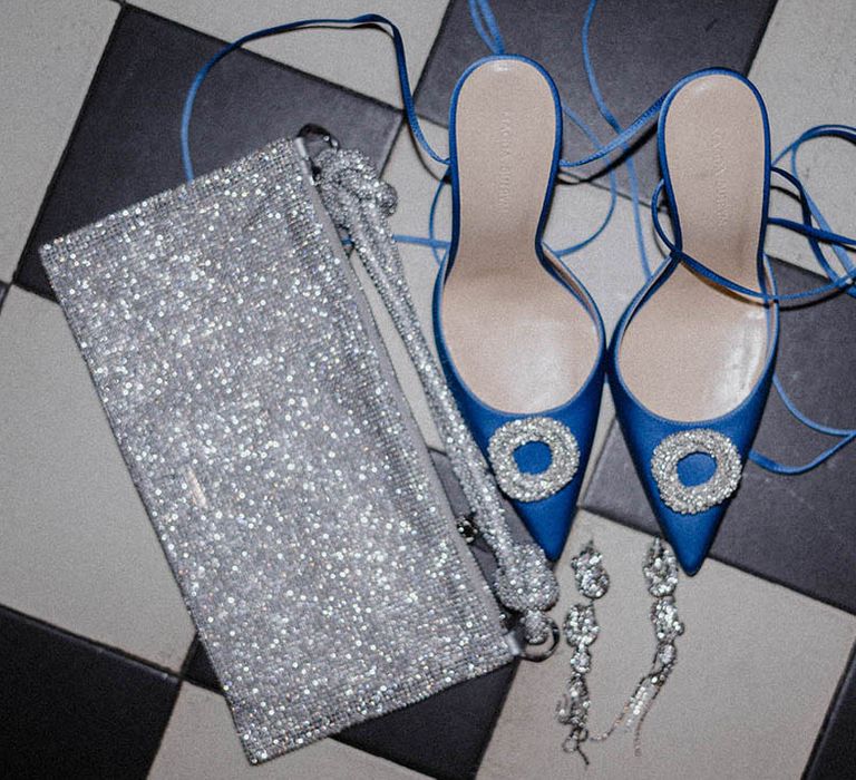 Silver sparkly clutch bag with blue pointed stiletto shoes 