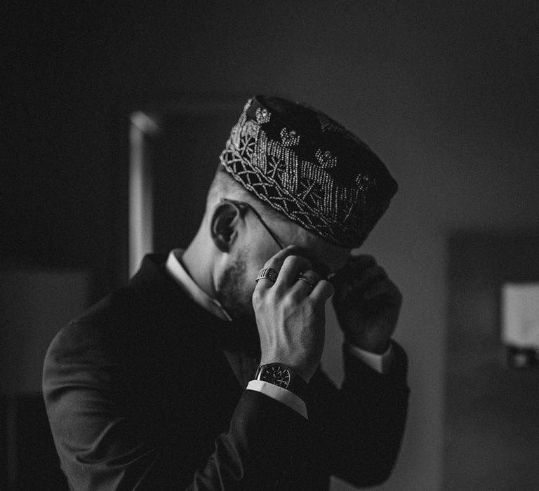 Groom wearing Kufi hat for multicultural Nigerian wedding 