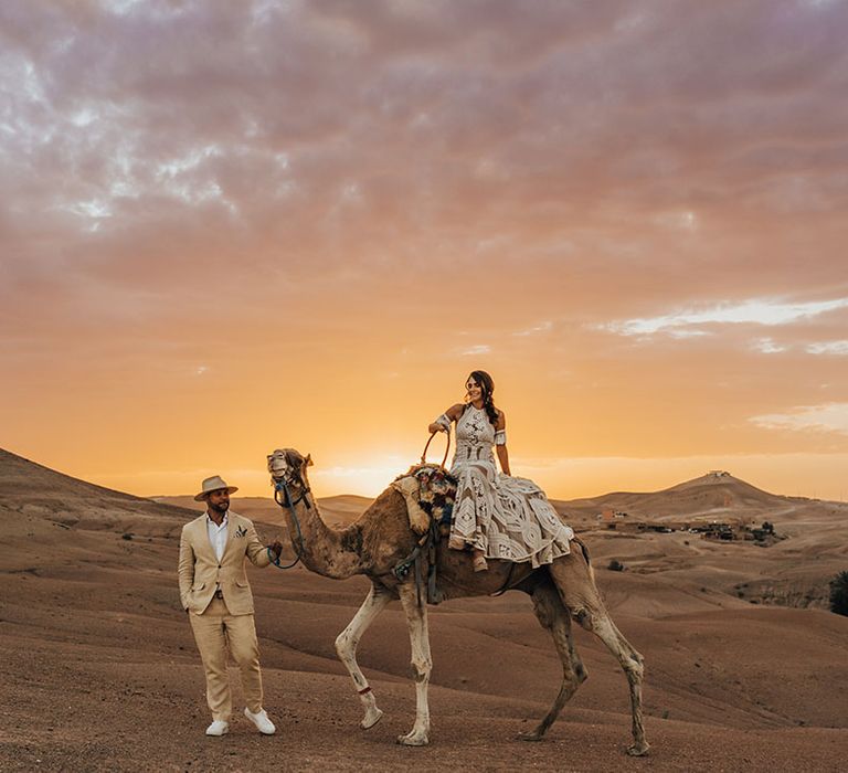 Romantic sunset wedding photography at desert elopement with camels 