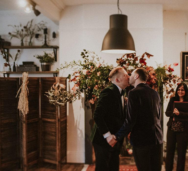 A first kiss between the two grooms at their same sex wedding ceremony as they are pronounced married 