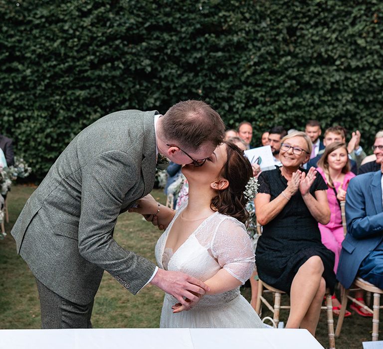 The happy couple share their first kiss as a married couple 