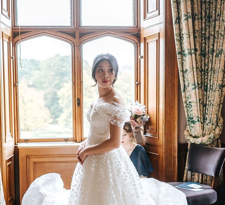 Bride in Sassi Holford off the shoulder wedding dress for classic country house wedding 