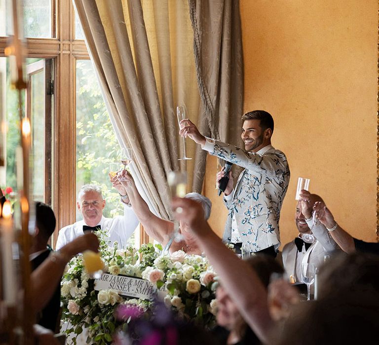 Groom makes a toast at the wedding breakfast for luxe country house gay wedding 