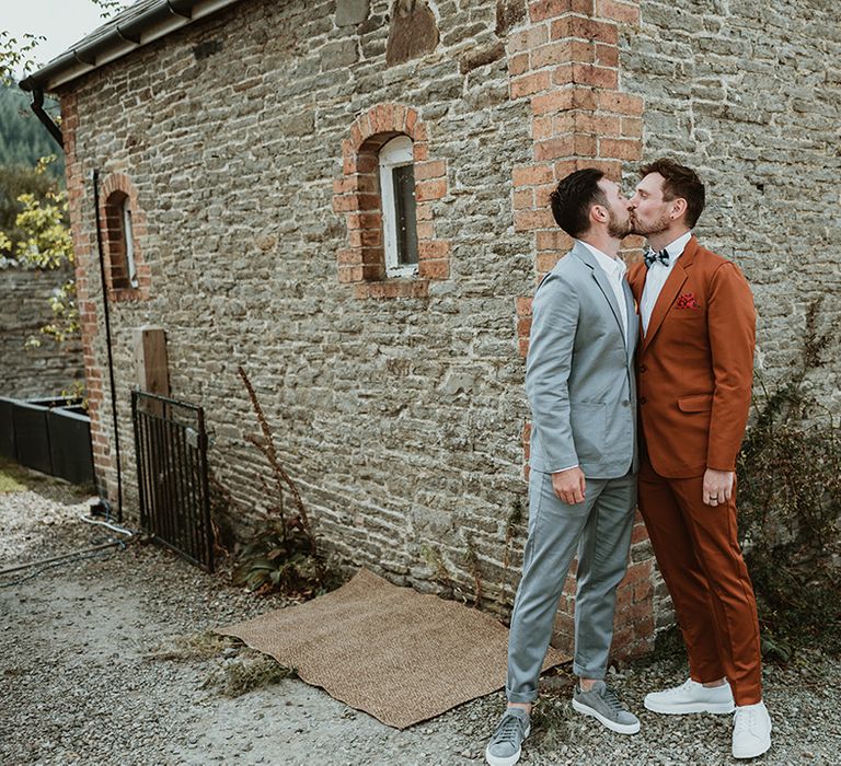 The grooms kiss as they have their romantic first look moment together 