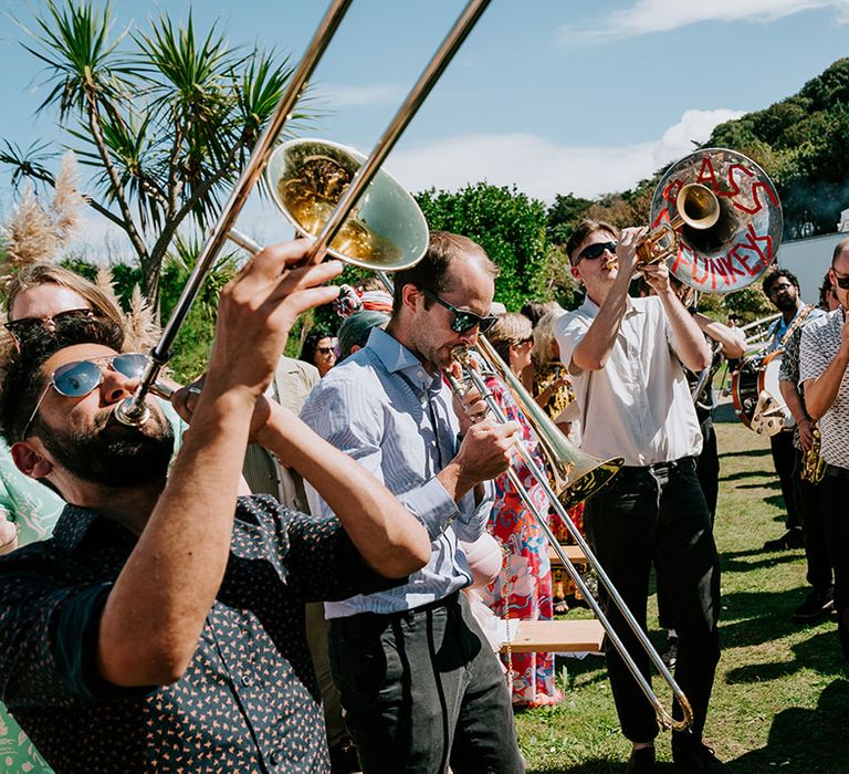 Live brass band plays during the wedding ceremony an leads guests to the cocktail hour 