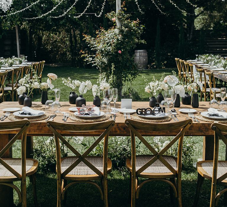 Black and white wedding place setting with fairy lights at Southern Spain destination wedding 