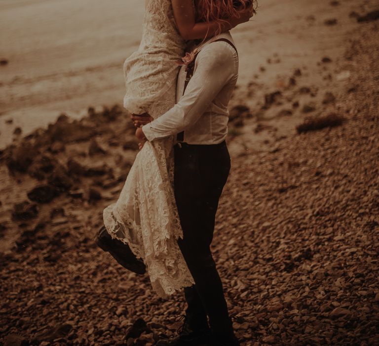 Bride and groom kissing at beach elopement