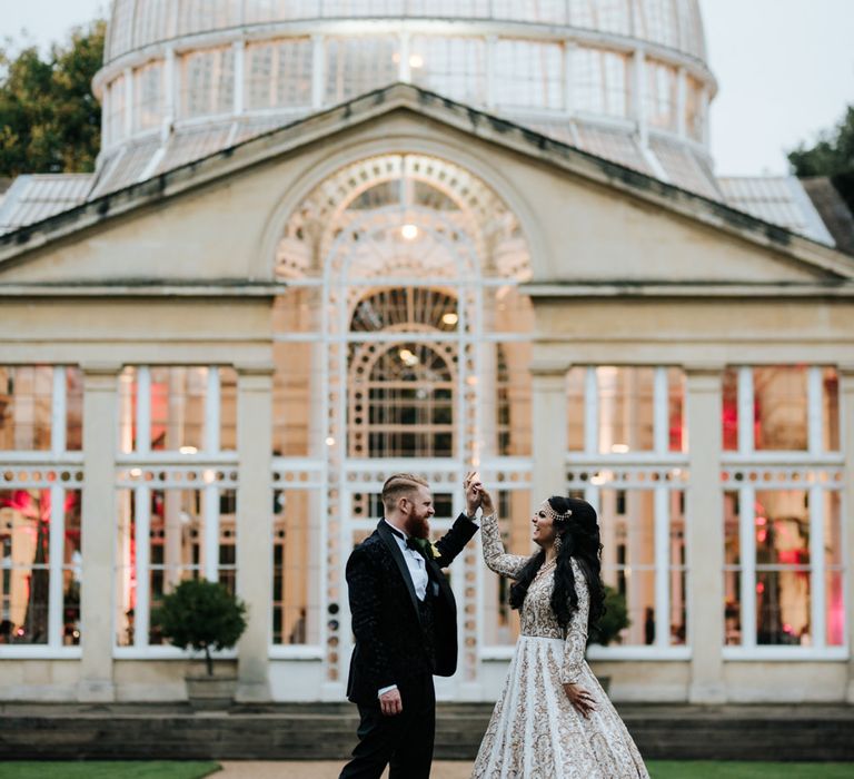 Bride and groom dancing in front of their Syon Park Orangery reception