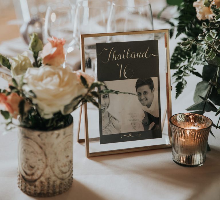 Table names in gold frames named after destinations the couple have travelled together 