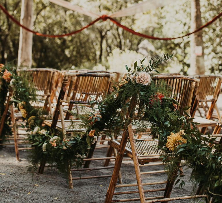 Floral garland decorating the aisle chairs