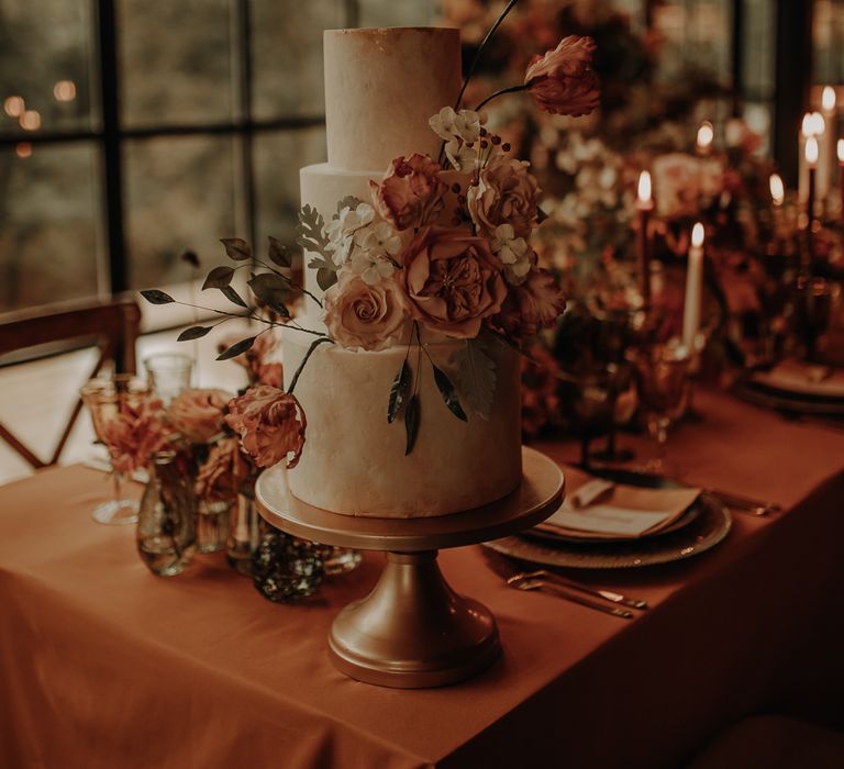 Three tiered wedding cake with autumn wedding flower decor 