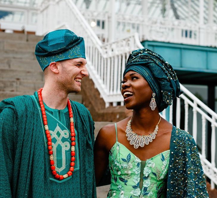 Bride and groom in green Nigerian outfits at Liverpool wedding 