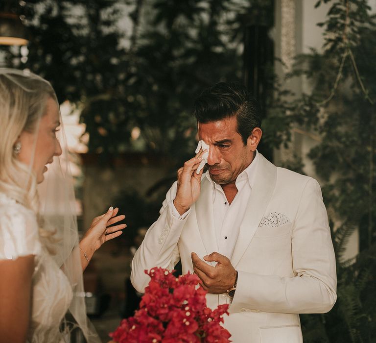 Emotional groom in white wedding suit at Marrakech wedding 