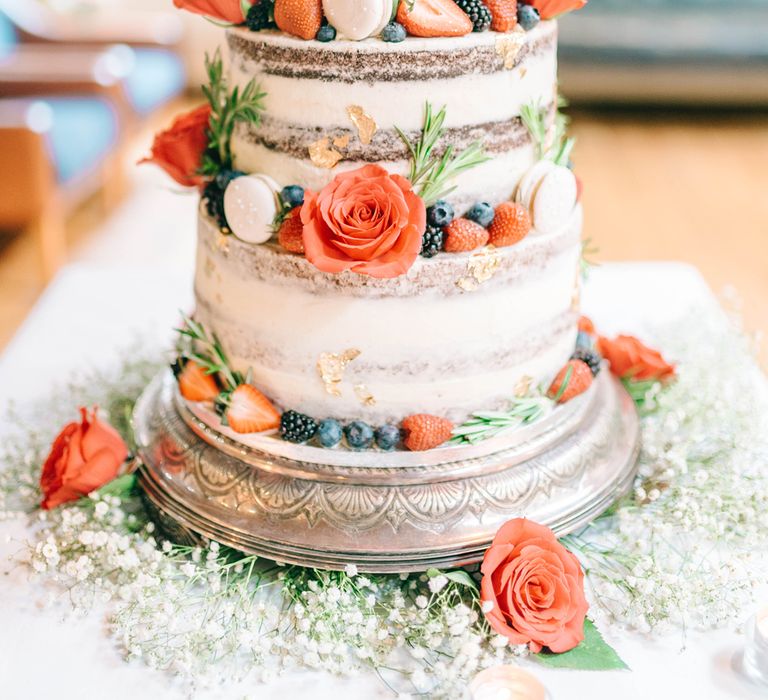 3 tier semi-naked vegan wedding cake with raspberries and strawberries