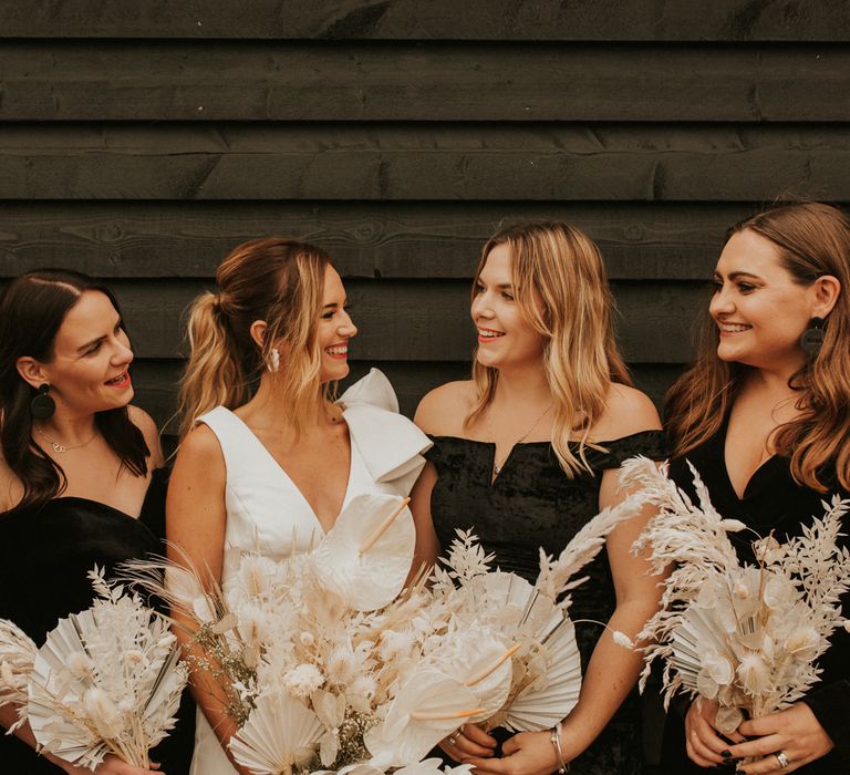 Bridal party portrait with bridesmaids in black dresses 