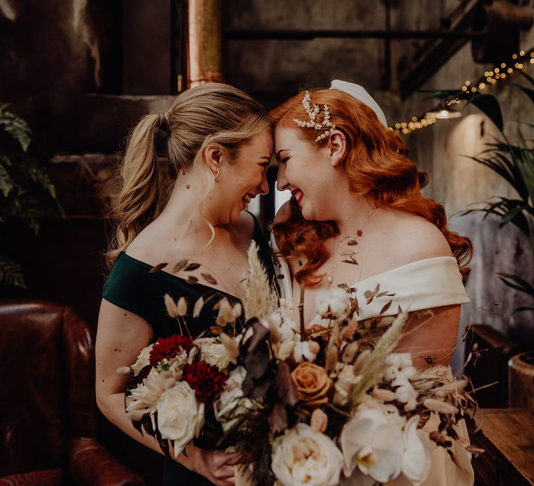 Bride with vintage wedding hair and bridesmaid in black dress