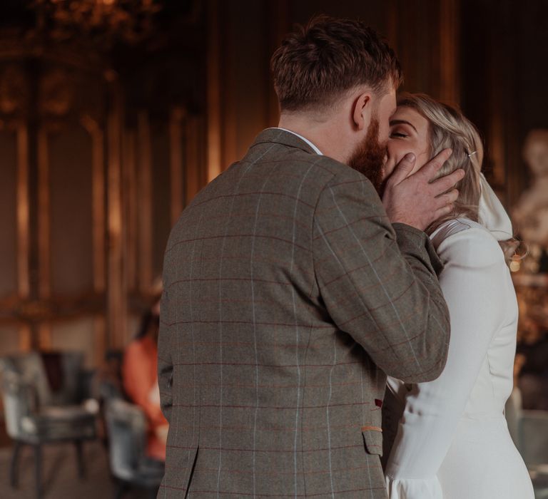 Bride & groom kiss during ceremony