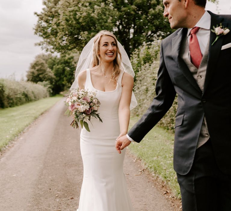 Bride in mermaid wedding dress with straps 