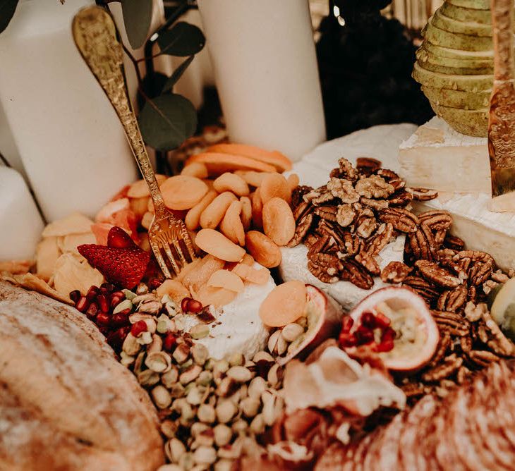 A close up shot of a grazing table full of cheese, grapes and cured meat.