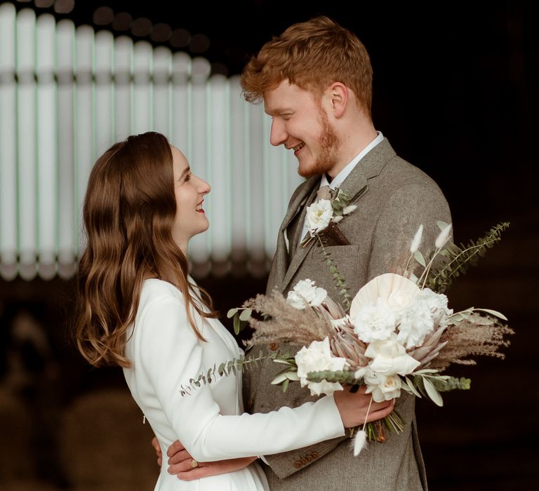 The bride and groom smiling, just married