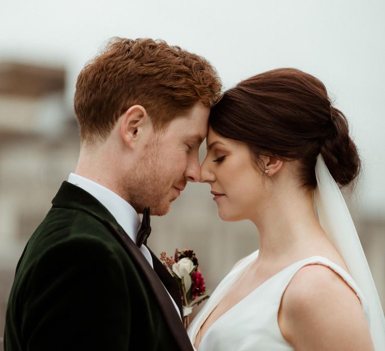 Bride and groom with their heads gently together 