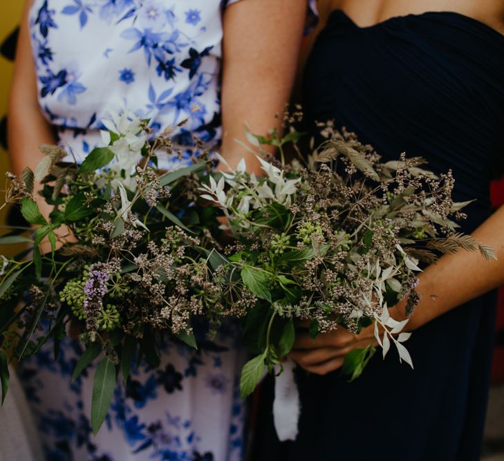 Close up of bridesmaids holding foliage bouquets