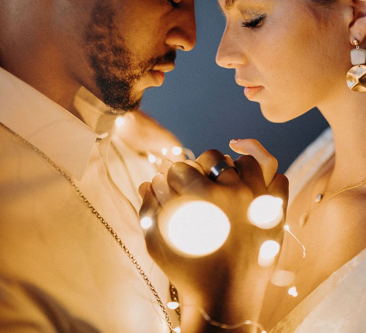 Intimate bride and groom portrait with fairy lights 