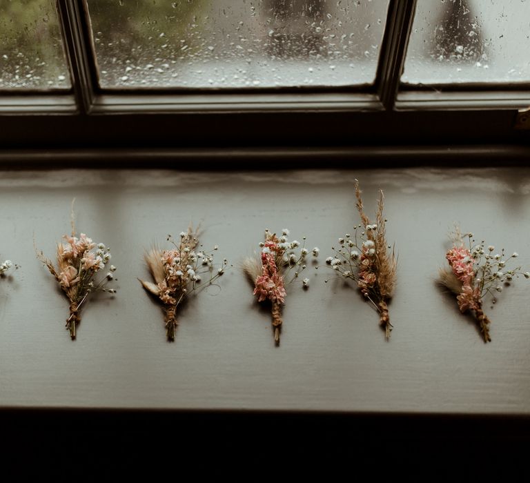 Dried and fresh flower buttonholes with pampas grass and gypsophila 