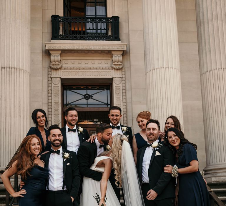 Bride & groom pose with wedding party