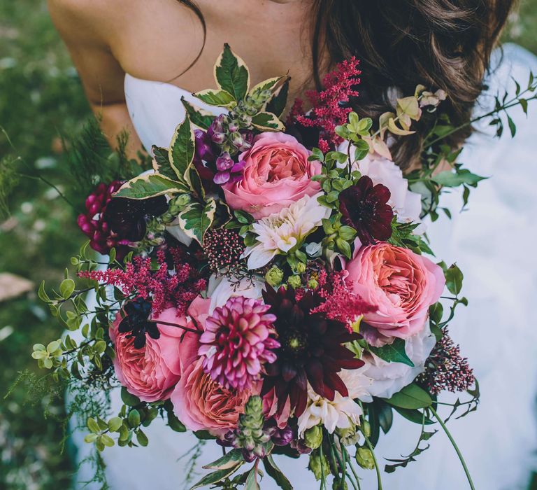 Bride holding bright pink rose wedding bouquet