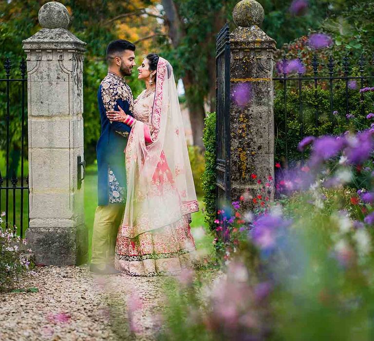 Bride and groom embrace at Elmore Court Hindu fusion wedding