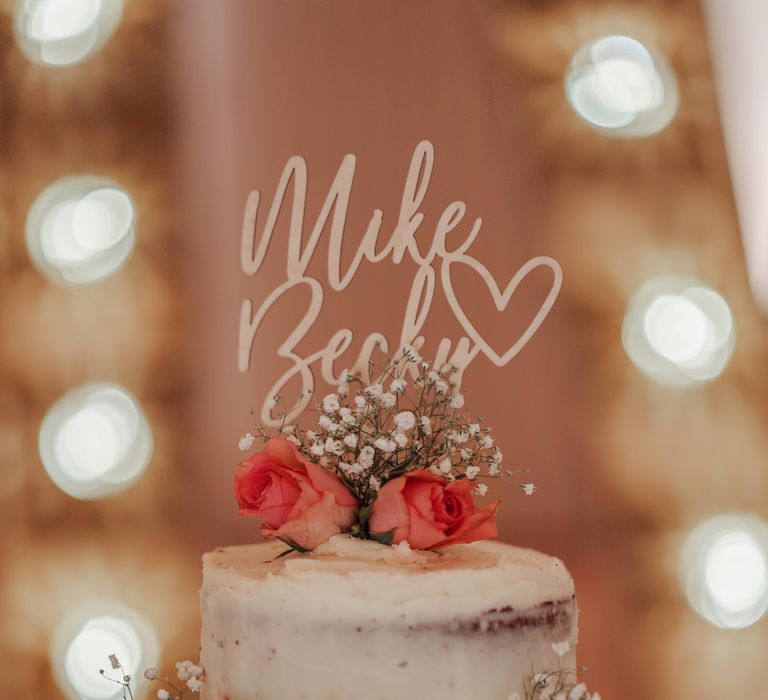 3-tier wedding cake with naked frosting and fruit decoration 