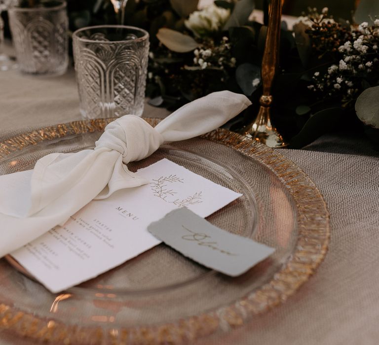 gold rimmed glass charger plate with menu and place cards on the day wedding stationery 