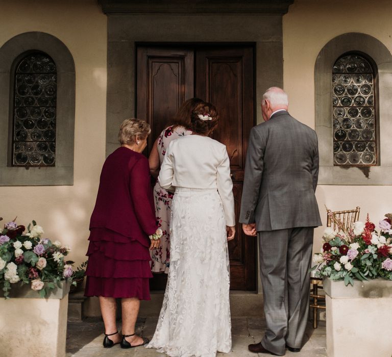 Bride enters the Chapel with her parents on her wedding day