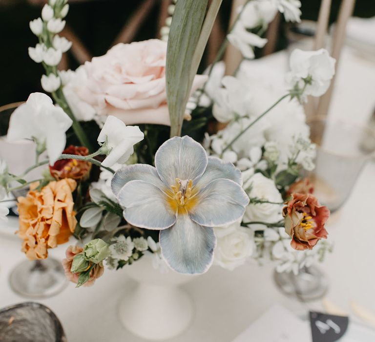 Wedding flower arrangements with blue, white and orange flowers 