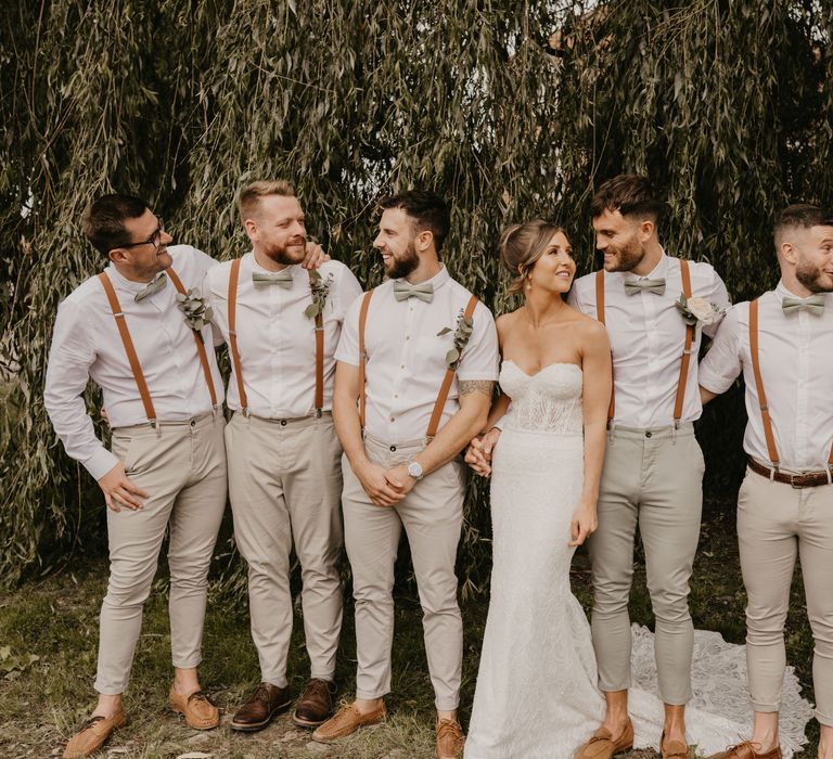 Bride & groom stand with groomsmen on their wedding day for farm wedding | Mark Bamforth Photography