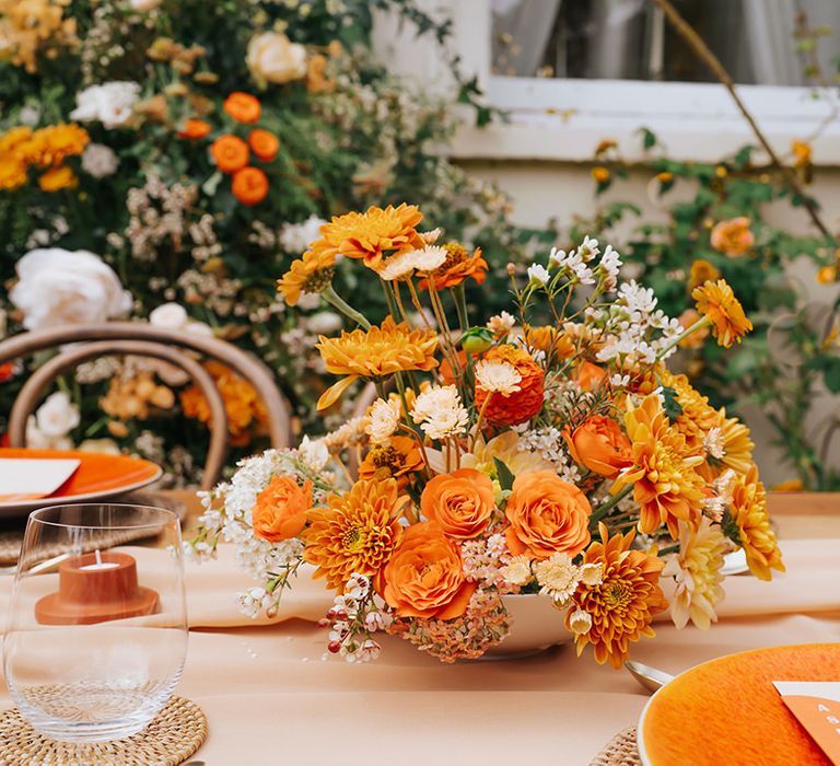 Orange flower centrepiece with dahlias, ranunculus and carnations 