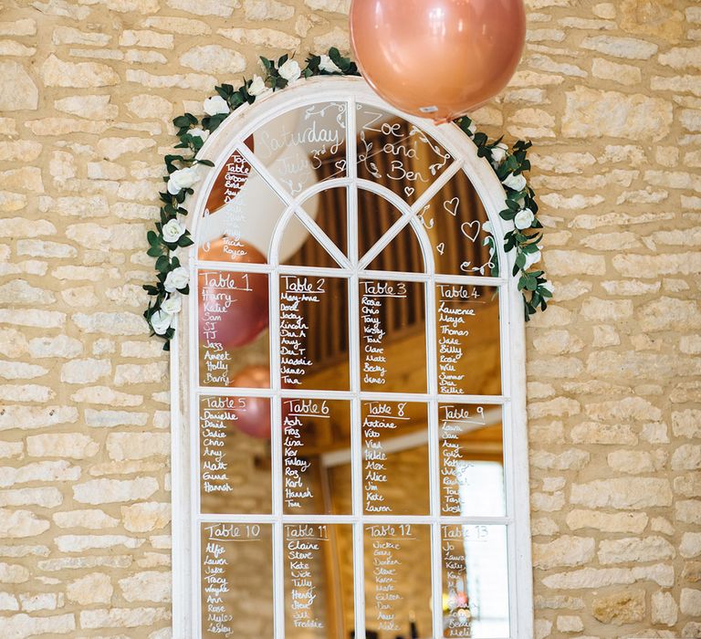 White window pane wedding seating plan with white ink and vine decoration 