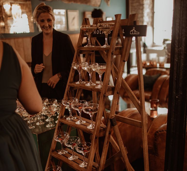 Champagne glasses on wooden stepladder 