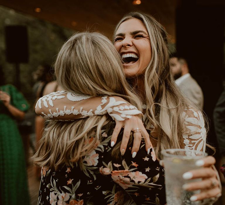 Bride hugs wedding guest