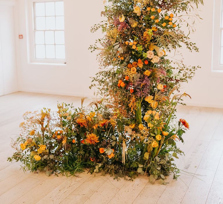 golden orange and yellow column wedding flowers at Core Clapton Events wedding venue 