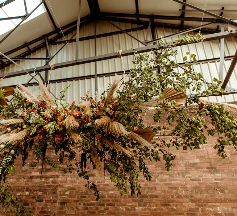 Stunning flower cloud with foliage, dried flowers including pampas grass and coral, peach and pink coloured flowers and fans