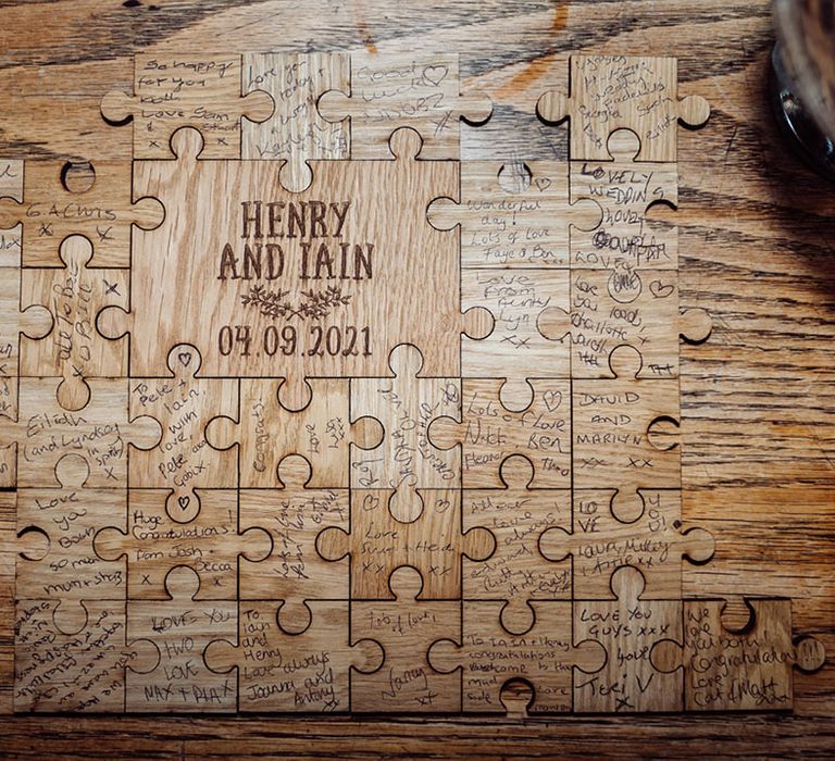 Puzzle piece style guestbook where guests can write personal messages to the couple that fit together as a large puzzle